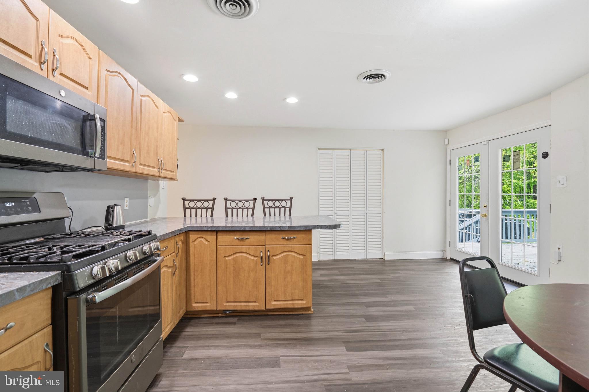 188 Carlisle Place Road Leesburg, NJ 08327 - Photo 12 of 36 a kitchen with stainless steel appliances granite countertop a stove a sink dishwasher and a microwave oven with wooden floor
