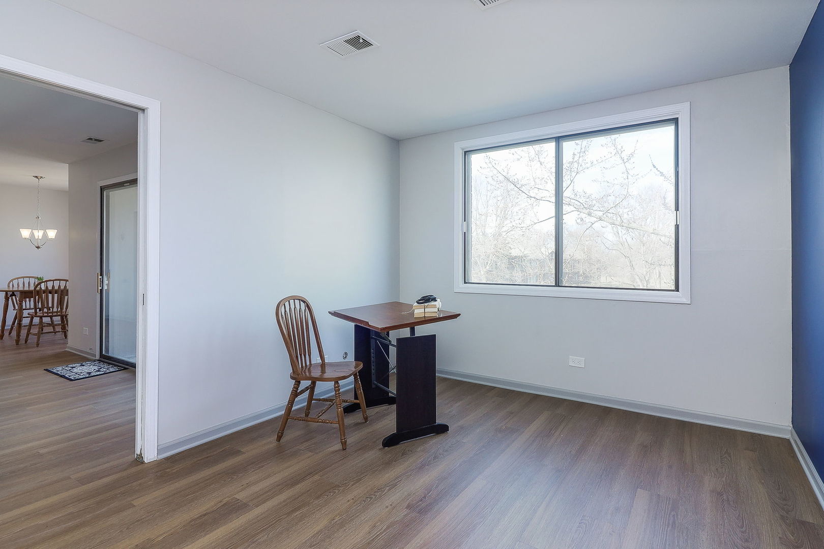 440 Raintree Court, Unit 2D Glen Ellyn, IL 60137 - Photo 15 of 23 a room with wooden floor and windows