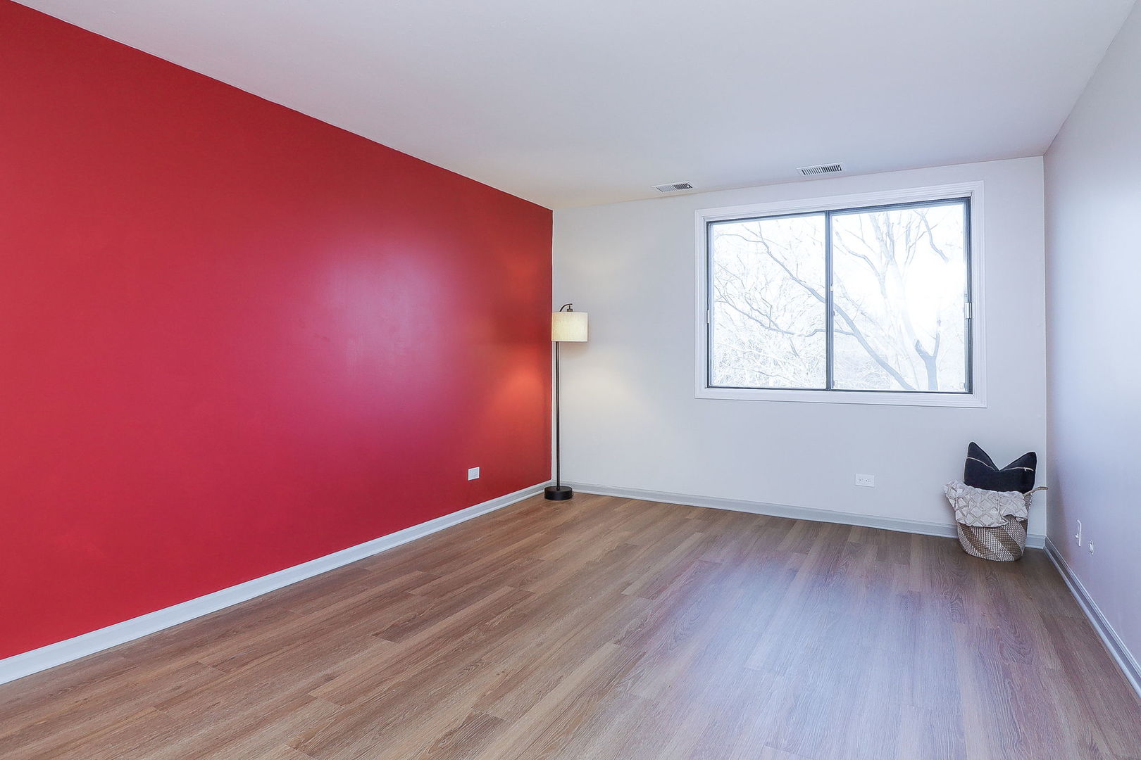 440 Raintree Court, Unit 2D Glen Ellyn, IL 60137 - Photo 9 of 23 an empty room with wooden floor and windows