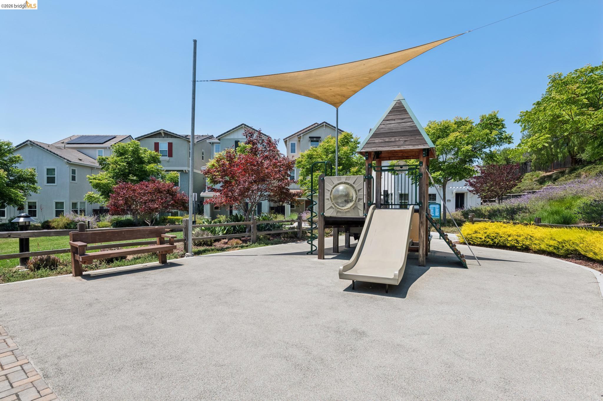 24157 Amaranth Loop Hayward, CA 94541 - Photo 60 of 63 Community playground featuring a slide, play structure, and sunshade