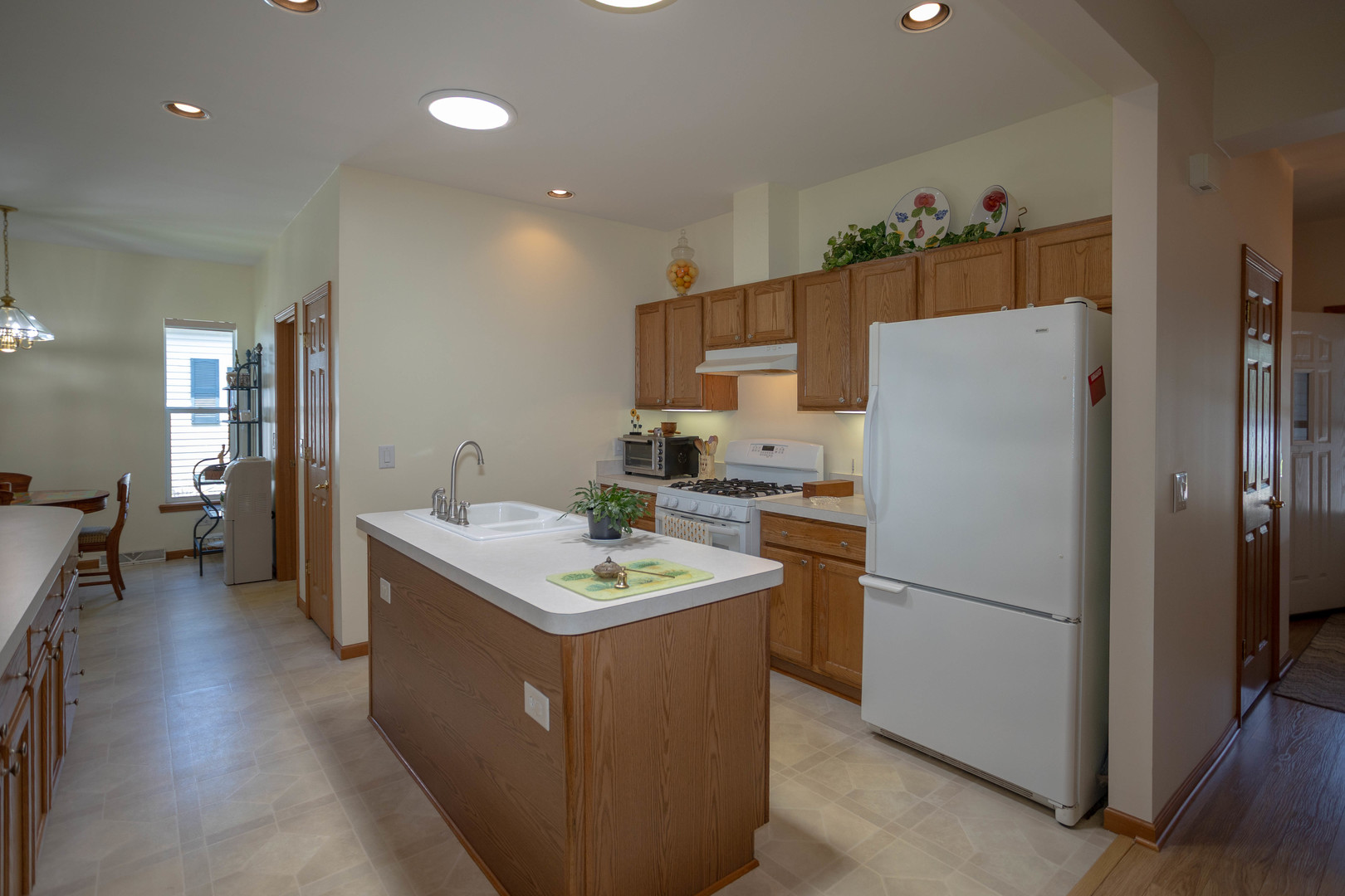 212 Rodeo Drive, Unit 2179 Grayslake, IL 60030 - Photo 8 of 31 a kitchen with a sink a refrigerator and cabinets