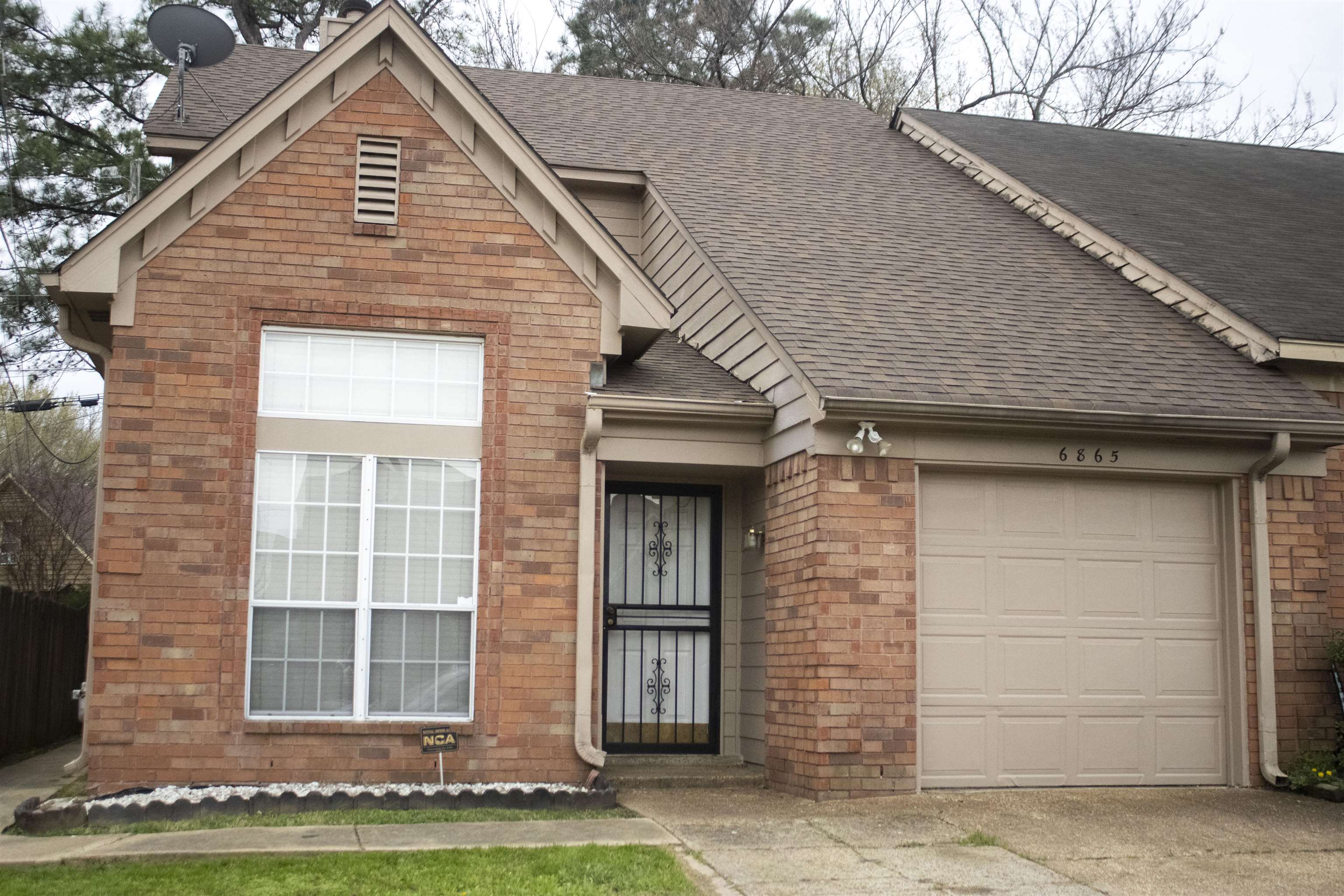 6865 Snyder Road Memphis, TN 38141 - Photo 1 of 10 a view of a brick house with a large windows