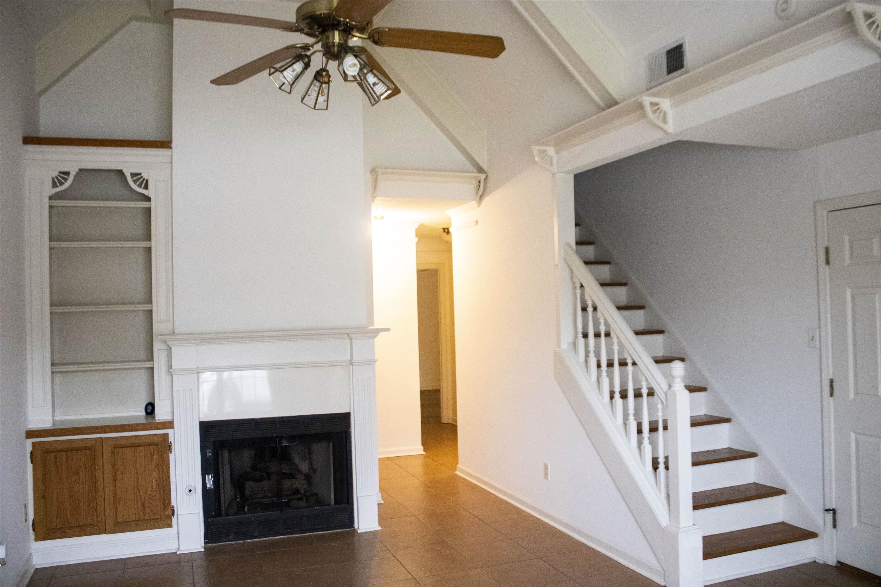 6865 Snyder Road Memphis, TN 38141 - Photo 2 of 10 a view of a livingroom with a fireplace and stairs