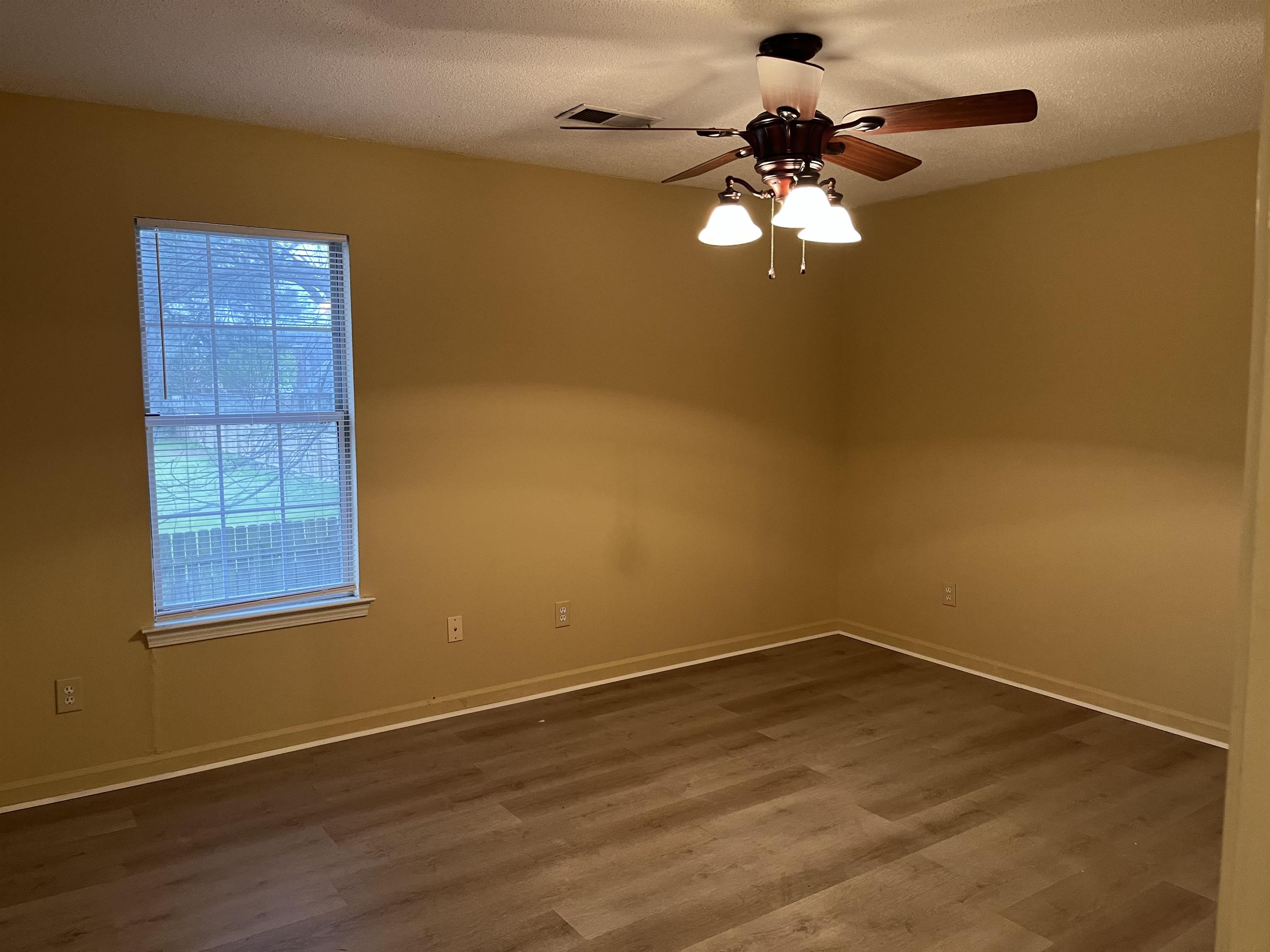 6865 Snyder Road Memphis, TN 38141 - Photo 8 of 10 a view of empty room with wooden floor