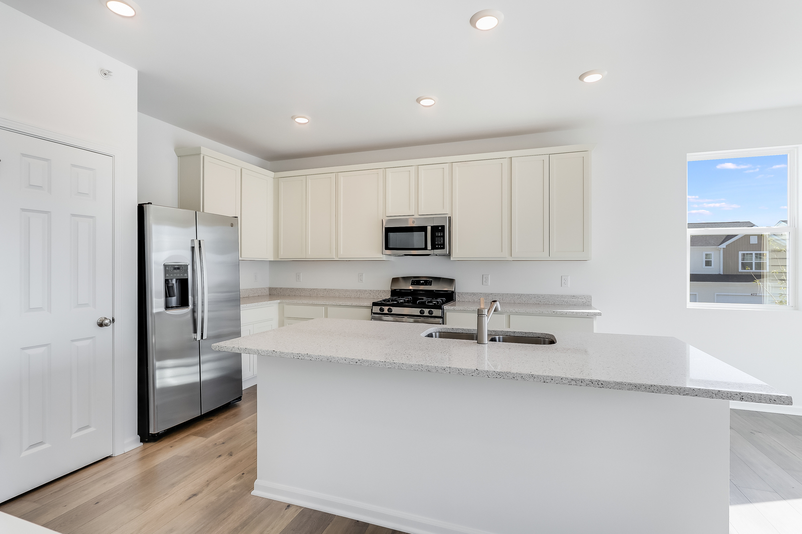 460 Comstock Road South Elgin, IL 60177 - Photo 13 of 31 a kitchen with white cabinets and stainless steel appliances