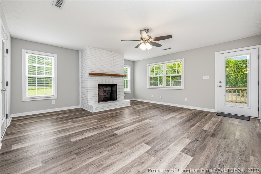 3524 Pine Log Road Lumberton, NC 28360 - Photo 24 of 42 a view of an empty room with wooden floor fireplace and a window