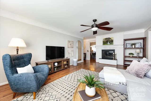 a living room with furniture a fireplace and a flat screen tv