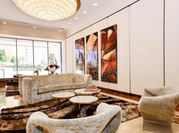a view of a livingroom with furniture and floor to ceiling window
