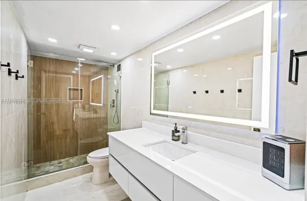 a bathroom with a glass shower door