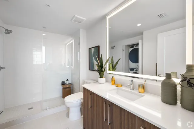 a bathroom with a sink a toilet and mirror