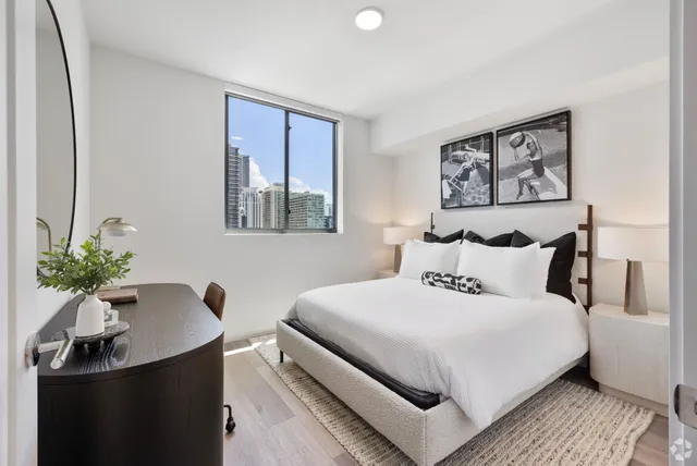 a bedroom with a bed and a potted plant