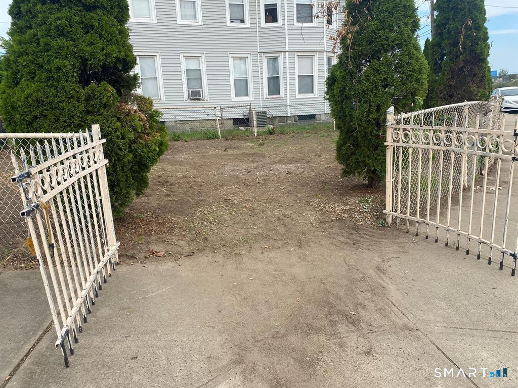 520 Seaview Avenue Bridgeport, CT 06607 - Photo 3 of 5 a view of a house with a yard and fence
