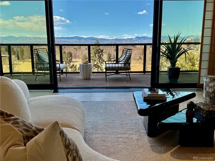 a living room with furniture large window and a flat screen tv
