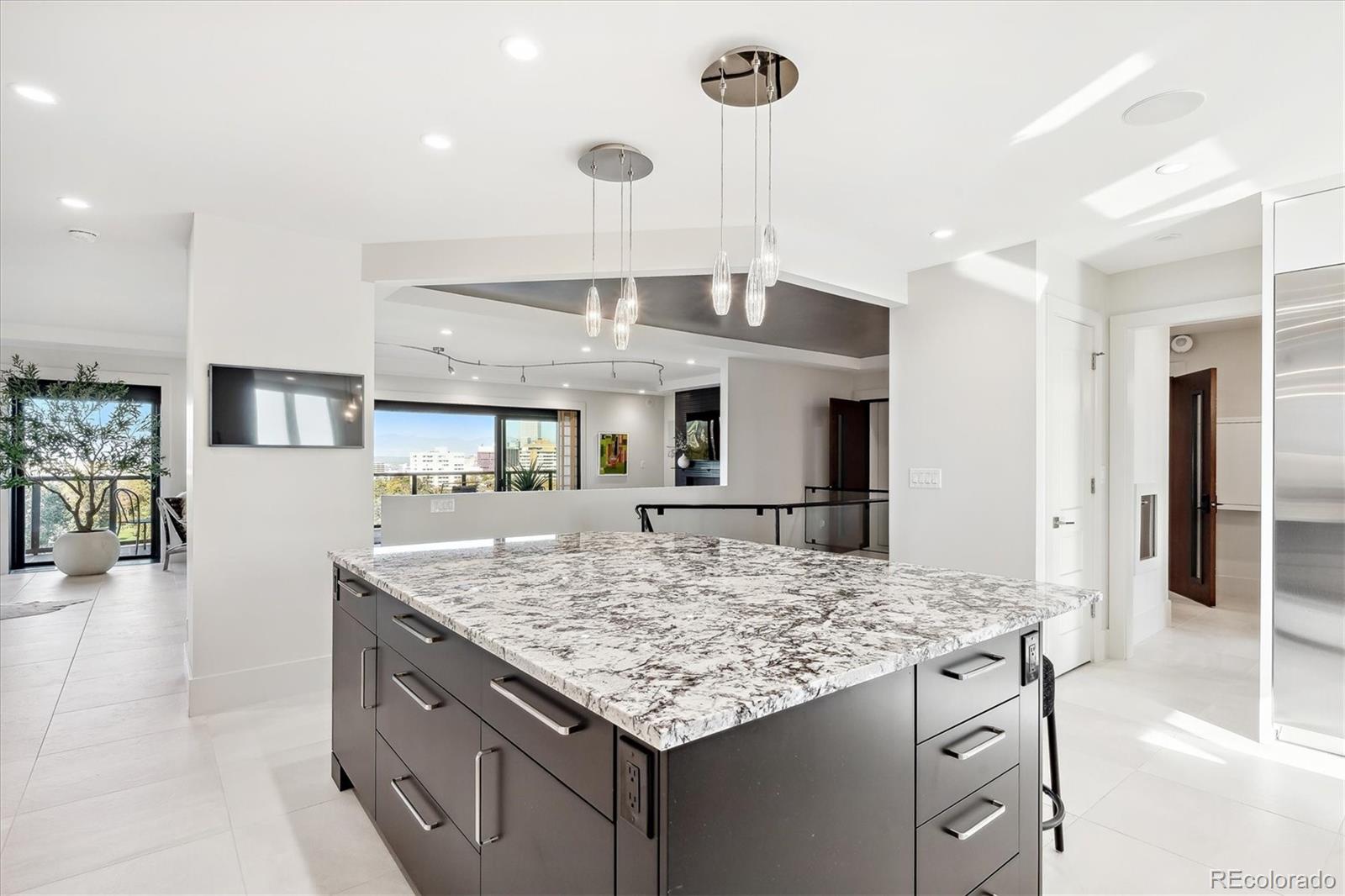 1133 Race Street, Unit 8 & 9 B Denver, CO 80206 - Photo 12 of 50 a kitchen with kitchen island granite countertop wooden cabinets and a counter top