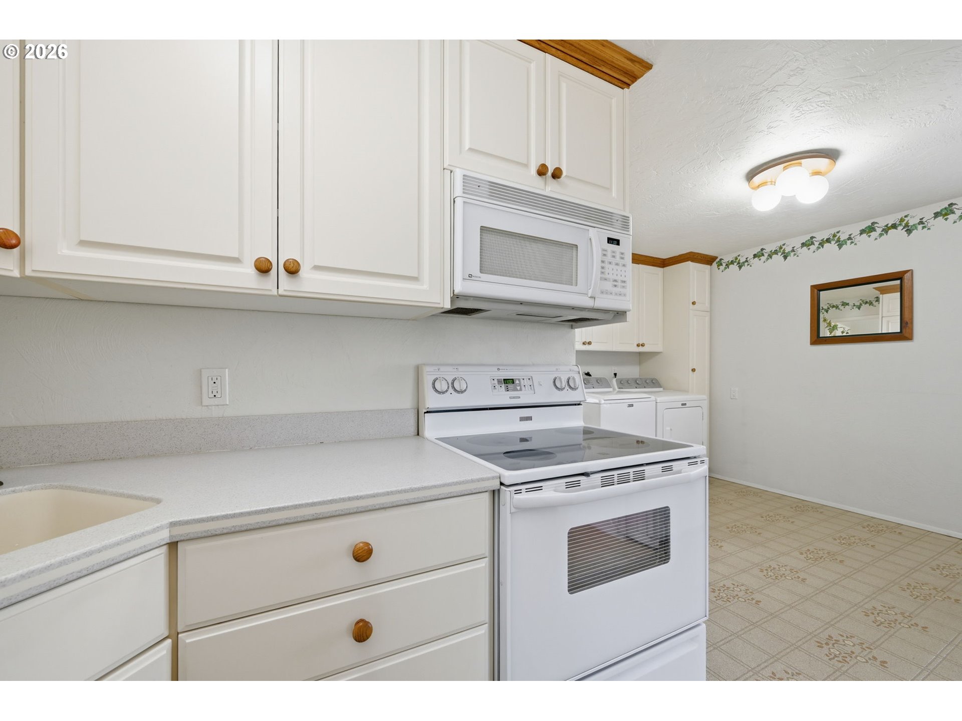 87856 Cedar Flat Road Springfield, OR 97478 - Photo 11 of 37 a kitchen with stainless steel appliances granite countertop a sink a stove and white cabinets