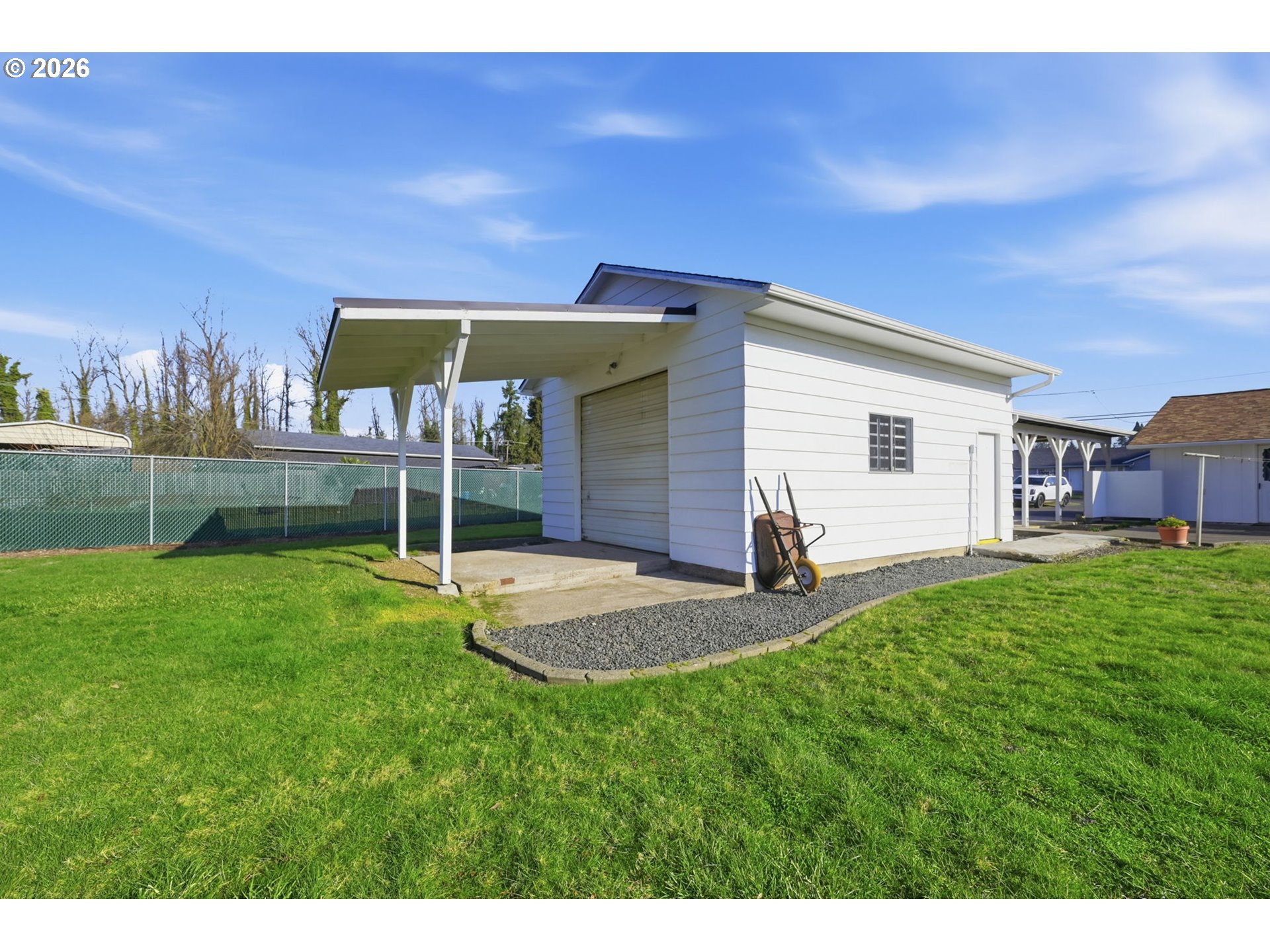 87856 Cedar Flat Road Springfield, OR 97478 - Photo 25 of 37 a view of a backyard with table and chairs under an umbrella