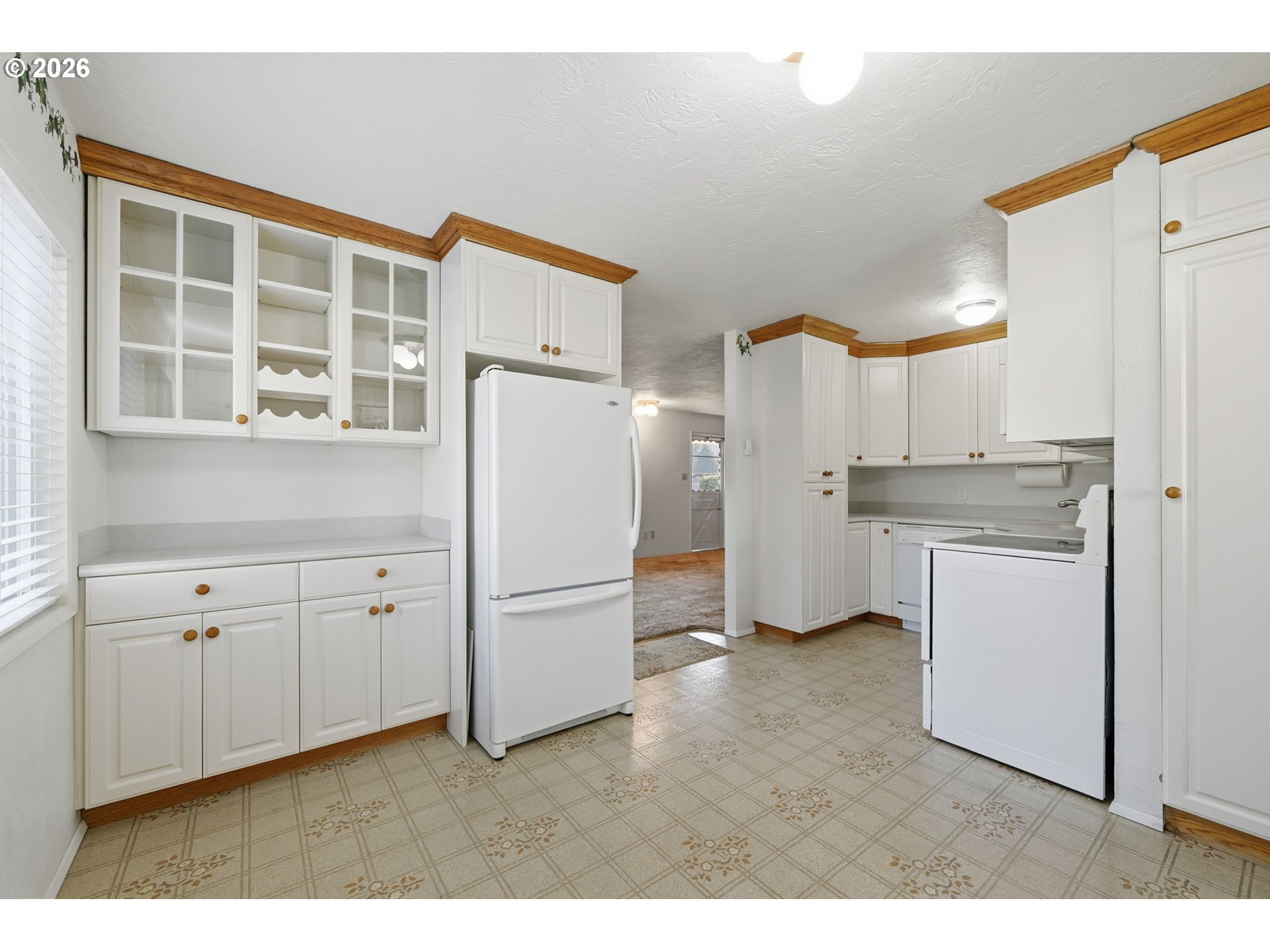 87856 Cedar Flat Road Springfield, OR 97478 - Photo 9 of 37 a kitchen with white cabinets and refrigerator