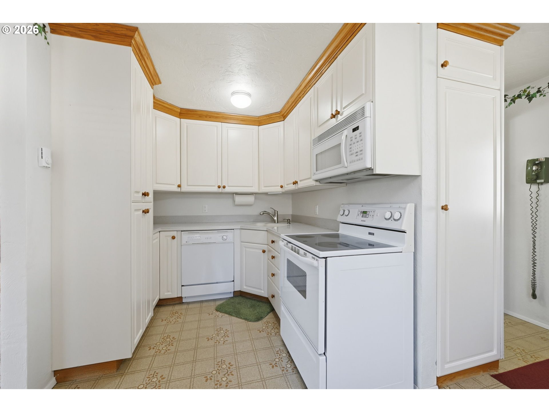 87856 Cedar Flat Road Springfield, OR 97478 - Photo 10 of 37 a kitchen with cabinets appliances a sink and a window