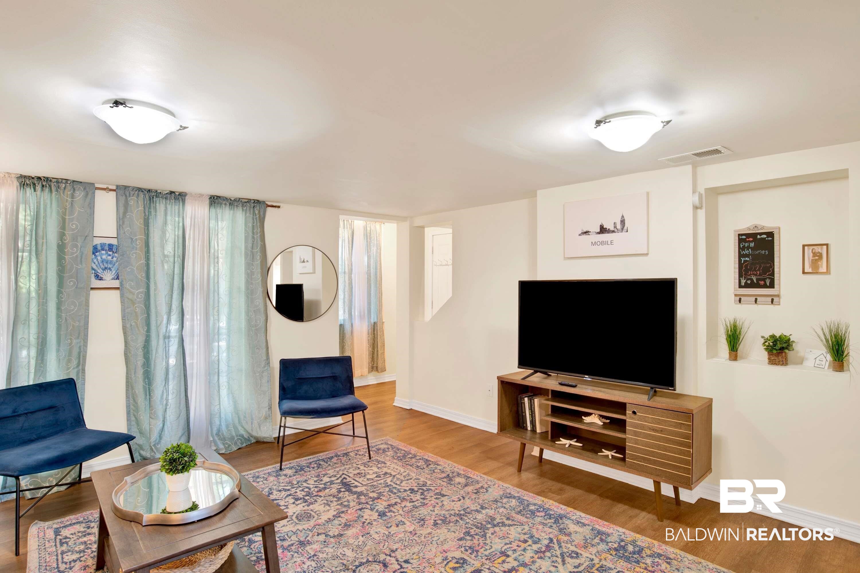 1141 Montauk Avenue Mobile, AL 36604 - Photo 6 of 15 Living room with baseboards, visible vents, and wood finished floors