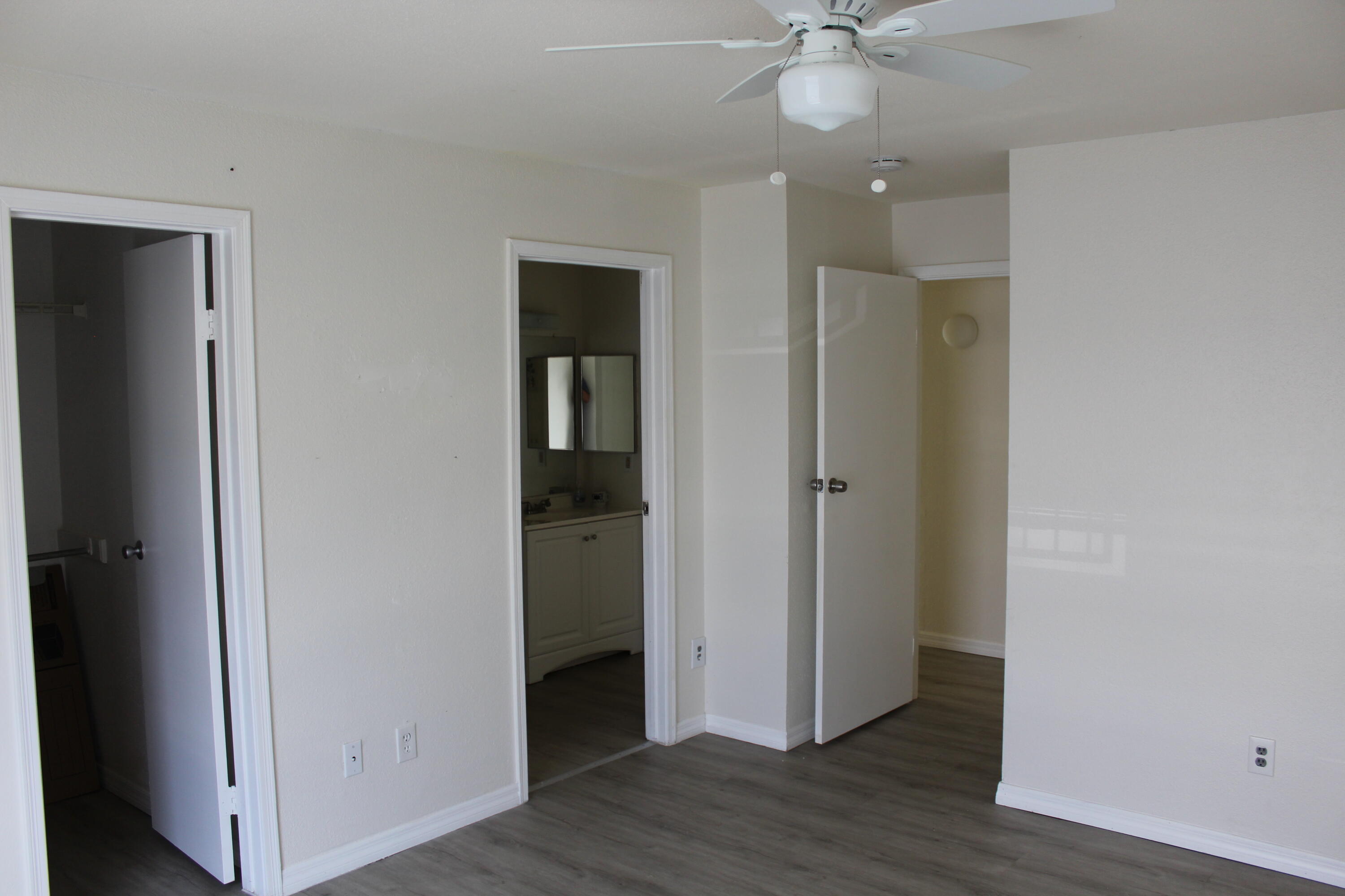 899 Riverside Drive, Unit 620 Coral Springs, FL 33071 - Photo 39 of 46 an empty room and wooden floor with closet area