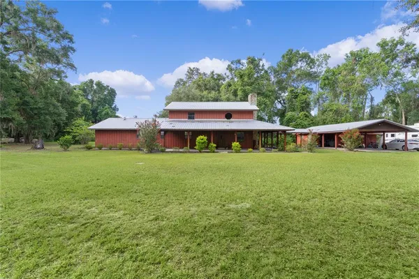 a front view of house with yard and trees