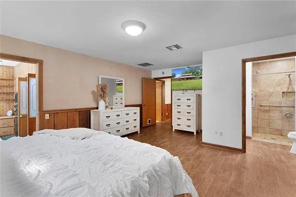 a room with gym equipment and a wooden floor