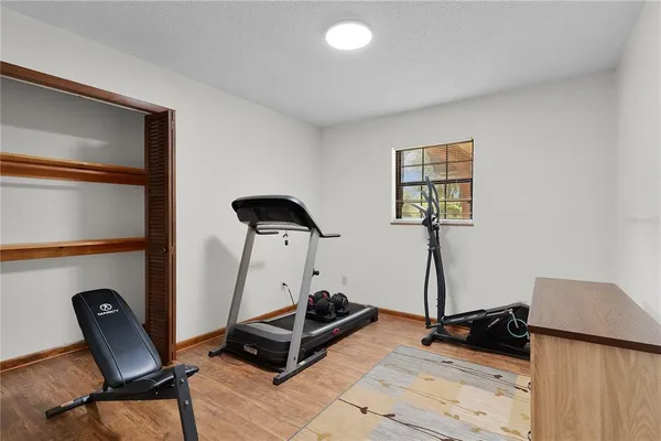 a view of a patio with table and chairs under an umbrella