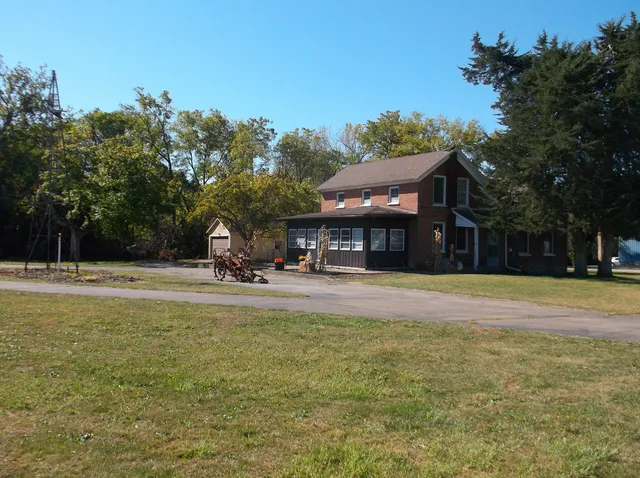 a view of a swimming pool with lawn chairs under an umbrella