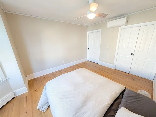 a view of a room with wooden floor and hallway