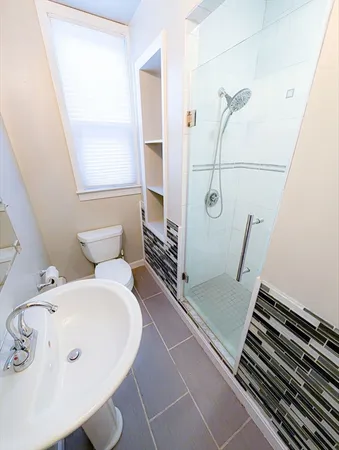 a bathroom with a tub and a window