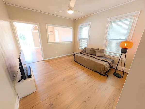 a spacious bedroom with a bed and a large window