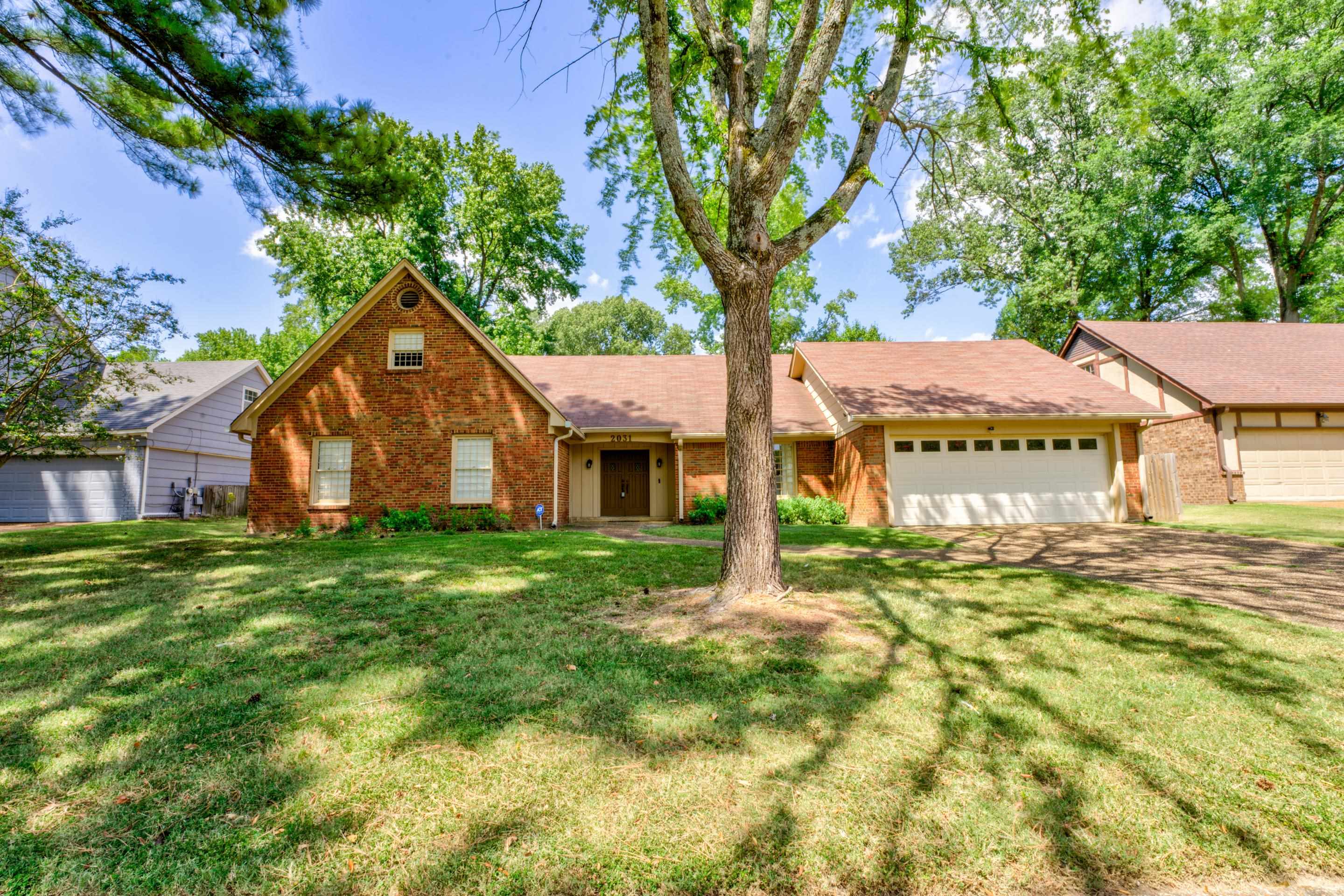 2031 Corbin Road Germantown, TN 38139 - Photo 1 of 27 View of front of property with a front yard and a garage