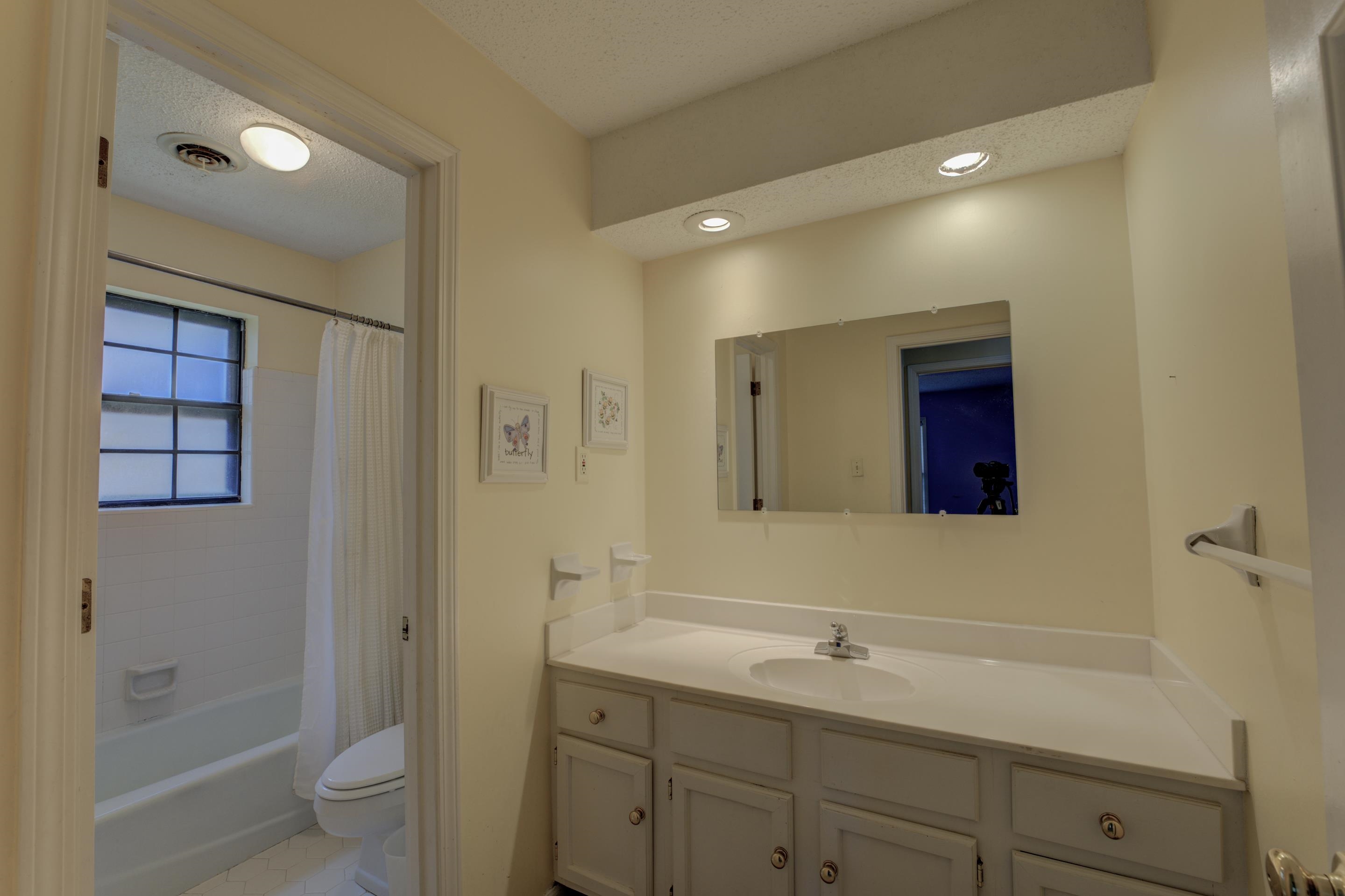 2031 Corbin Road Germantown, TN 38139 - Photo 14 of 27 Full bathroom featuring toilet, tile patterned flooring, vanity, shower / tub combo, and a textured ceiling