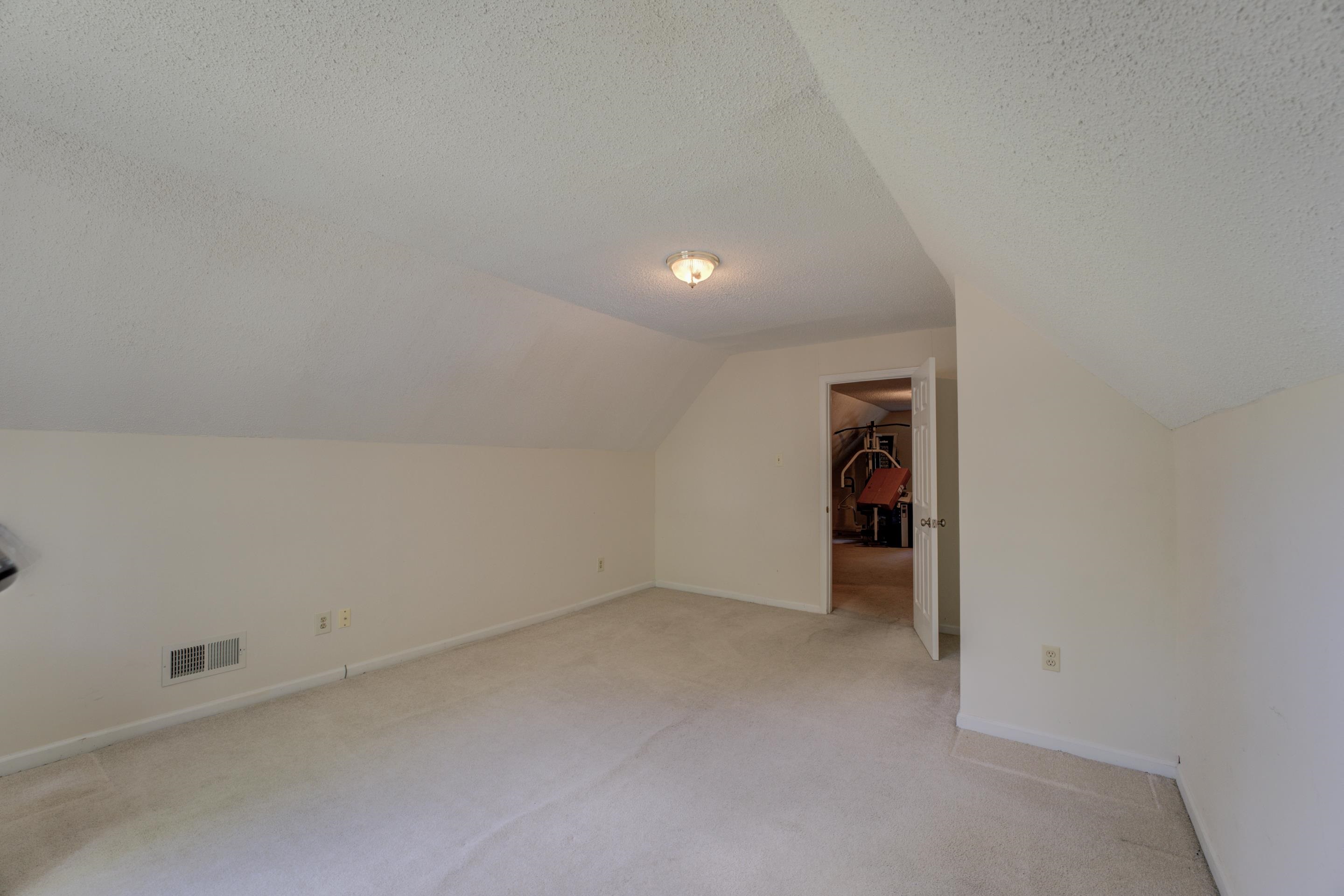 2031 Corbin Road Germantown, TN 38139 - Photo 19 of 27 Additional living space featuring vaulted ceiling, light colored carpet, and a textured ceiling