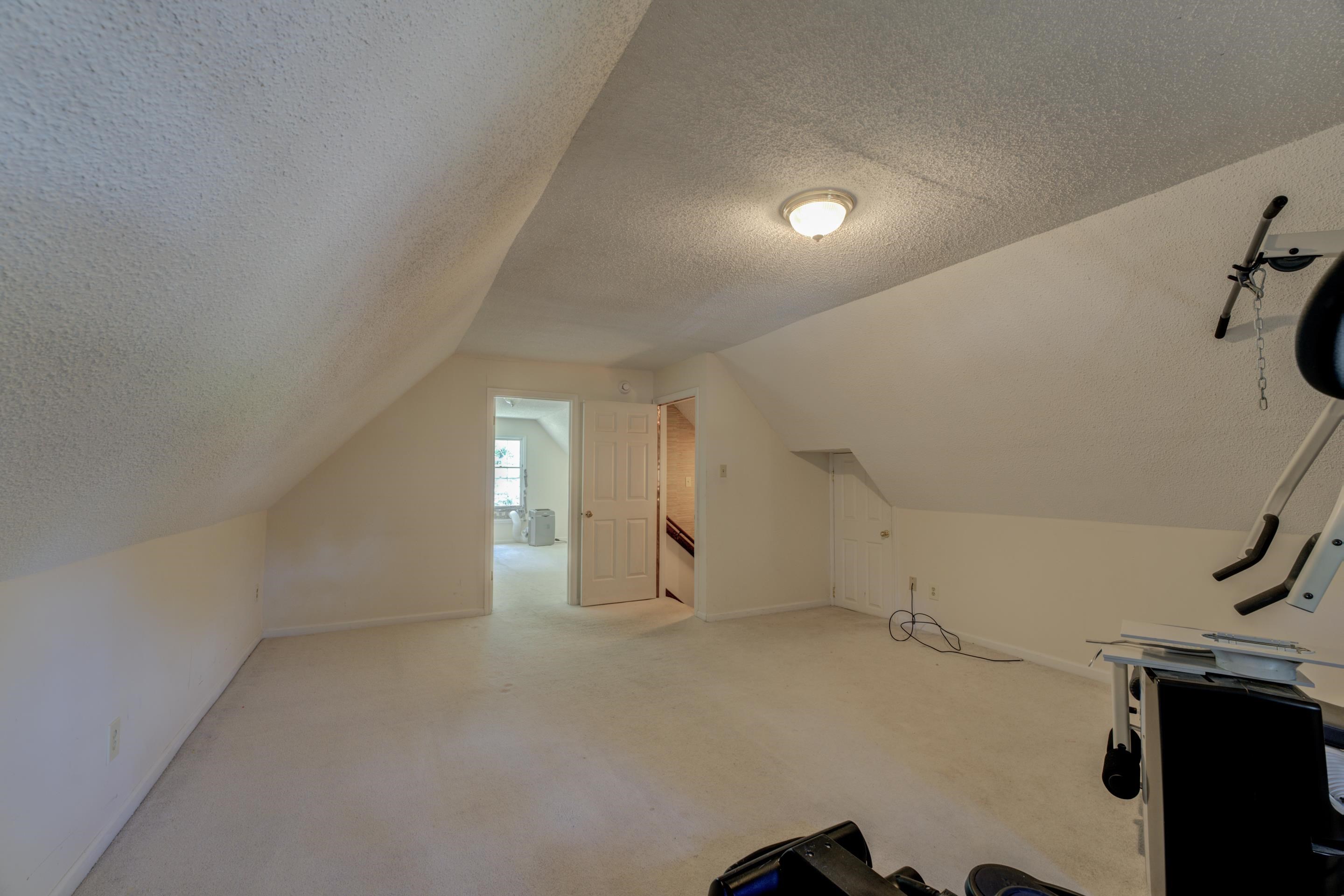 2031 Corbin Road Germantown, TN 38139 - Photo 21 of 27 Bonus room with light colored carpet, vaulted ceiling, and a textured ceiling