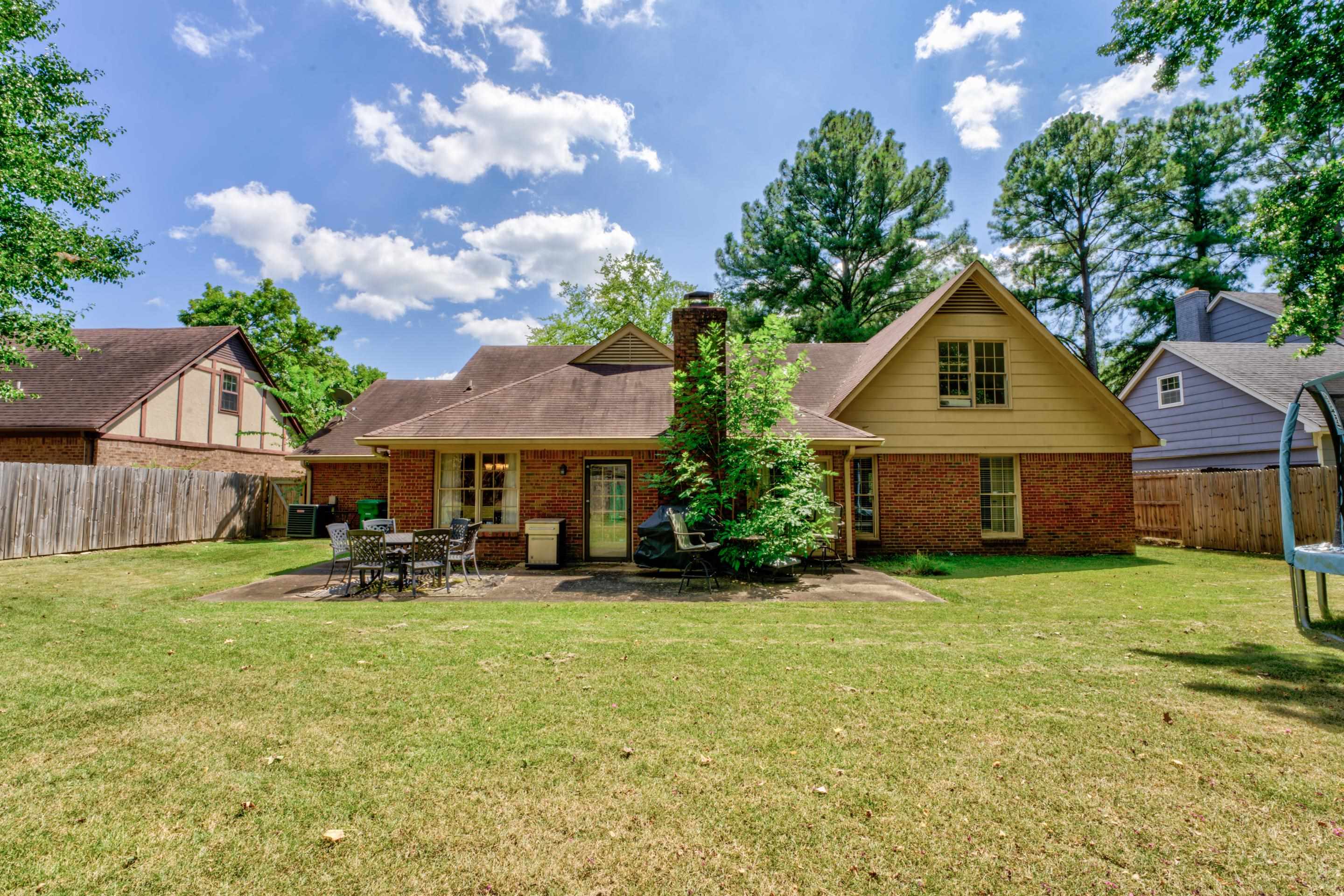 2031 Corbin Road Germantown, TN 38139 - Photo 24 of 27 Rear view of house featuring a patio area and a yard