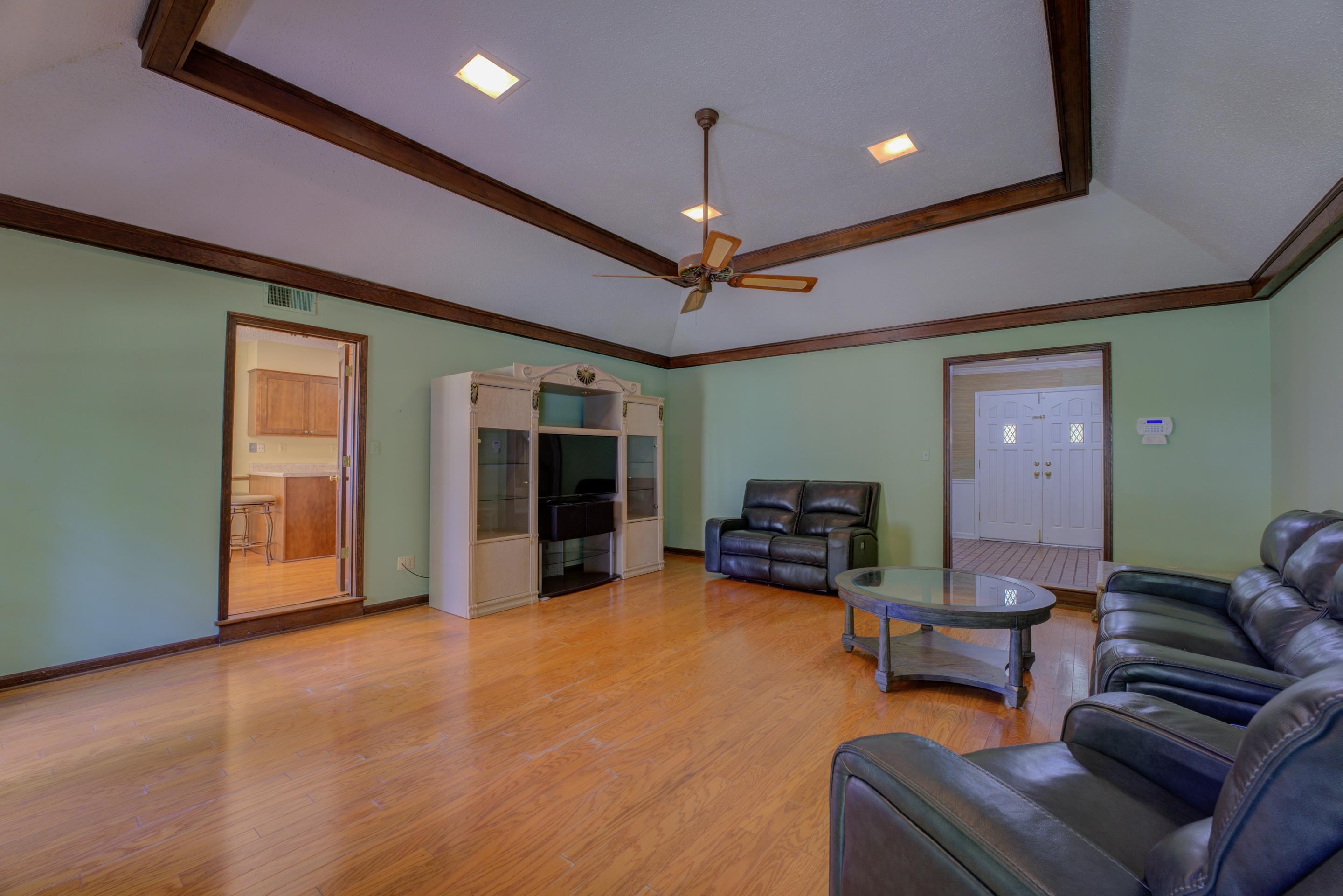 2031 Corbin Road Germantown, TN 38139 - Photo 4 of 27 Living room featuring a tray ceiling, light hardwood / wood-style flooring, and ceiling fan