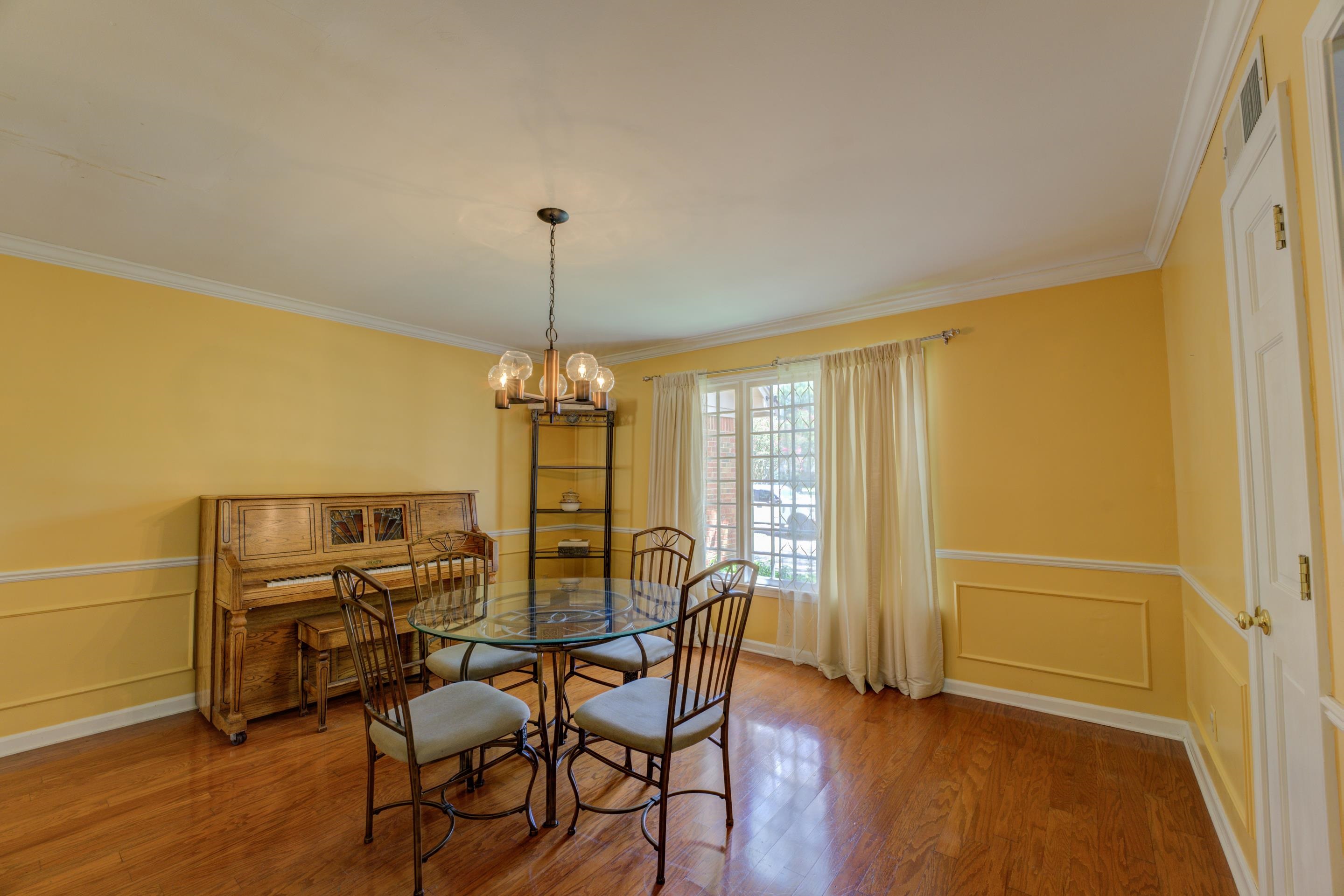 2031 Corbin Road Germantown, TN 38139 - Photo 10 of 27 Dining area with hardwood / wood-style flooring, crown molding, and a chandelier