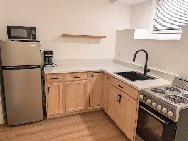 a view of kitchen with a sink and a stove top oven