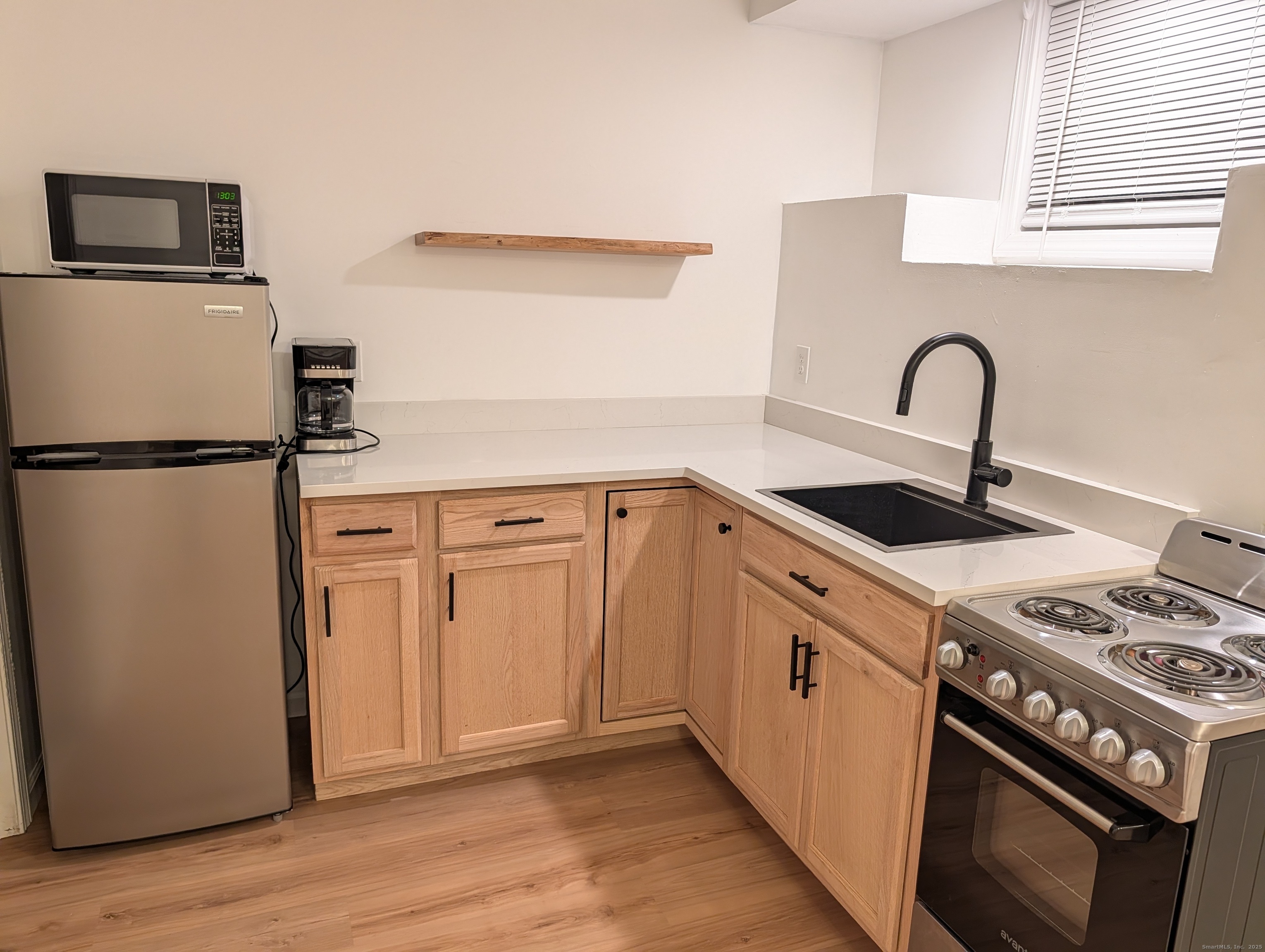 a view of kitchen with a sink and a stove top oven