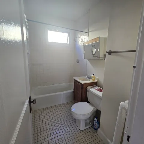a bathroom with a toilet a sink and bathtub