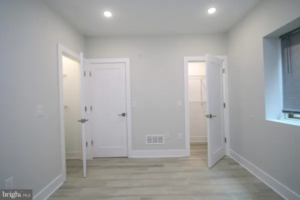 a view of room with window and wooden floor