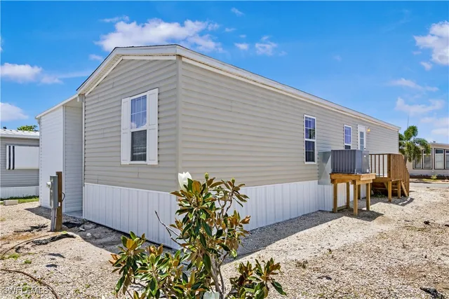 a view of a chairs and table in the backyard