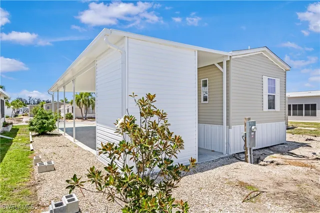 a backyard of a house with potted plants