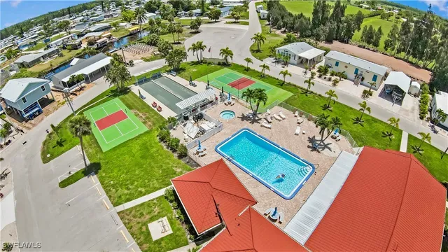 an aerial view of a house with a garden and swimming pool