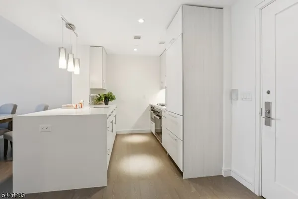 a utility room with cabinets washer and dryer