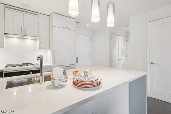 a kitchen with a table chairs stove and cabinets