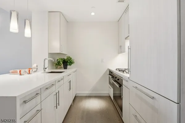 a kitchen with a sink and white cabinets