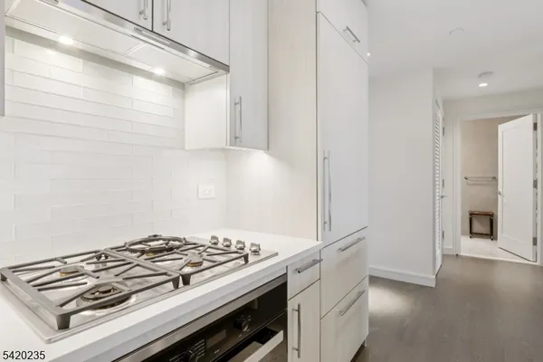 a stove top oven sitting inside of a kitchen
