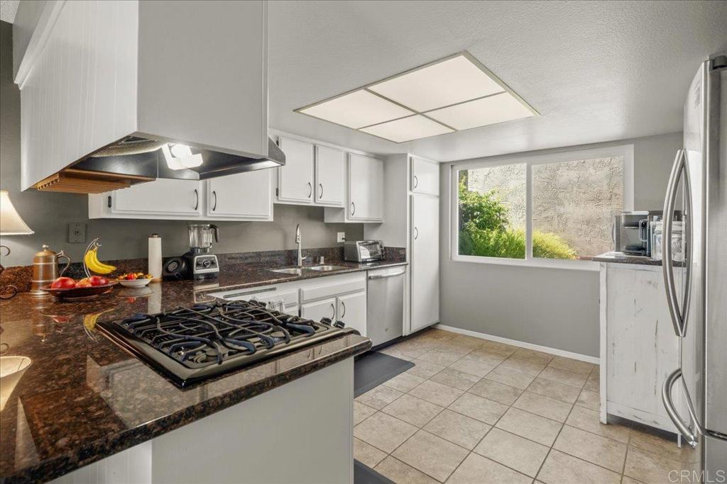 3047 Highlands Boulevard Spring Valley, CA 91977 - Photo 8 of 39 a kitchen with a stove a sink and a refrigerator